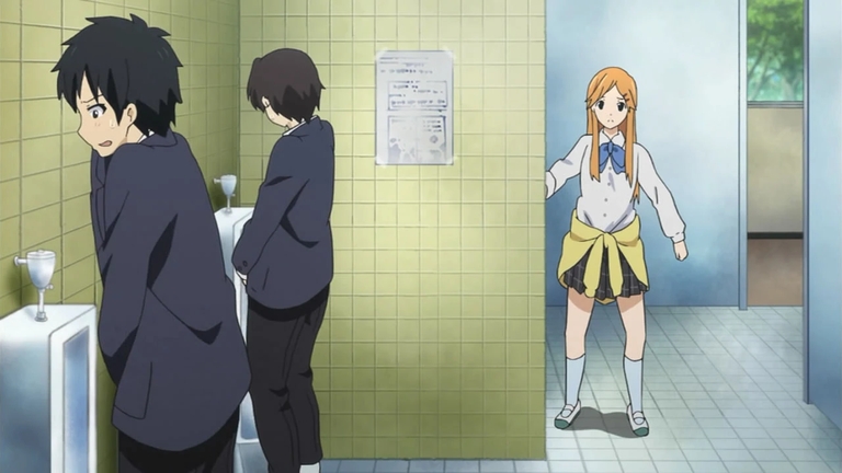 Taichi, surprised, stands in the men's restroom while Yui, in Taichi's body, looks on in confusion in this scene from Kokoro Connect.