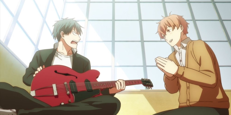 Ritsuka Uenoyama looking surprised while holding Mafuyu Sato's Gibson ES-330 guitar