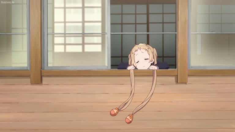 Blonde girl with pigtails resting at windowsill