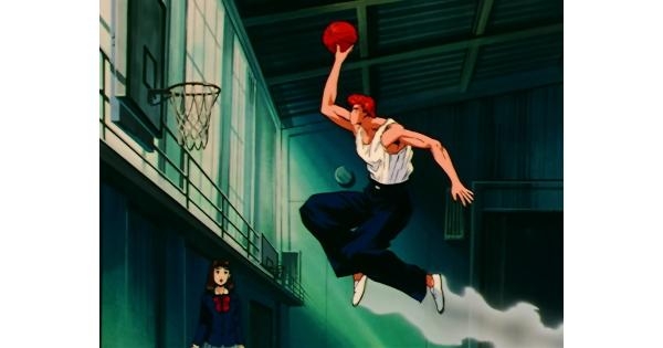 Hanamichi Sakuragi performing a slam dunk during a basketball game in the anime series Slam Dunk