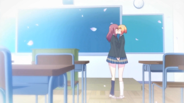 Haruka and Yuu share a kiss in an empty classroom in the anime series Sakura Trick.